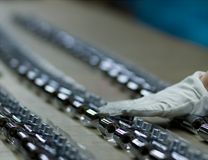 Staff inspecting components on the assembly line