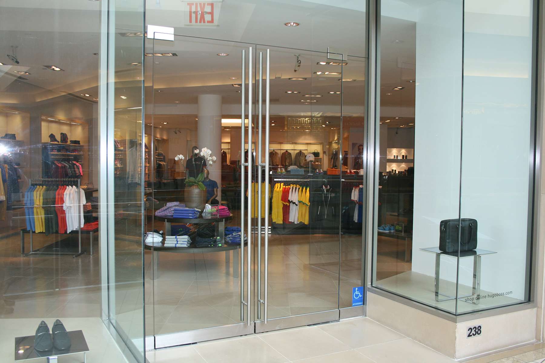 Detail of commercial glass entrance door with heavy-duty patch fittings and glass-mounted patch lock