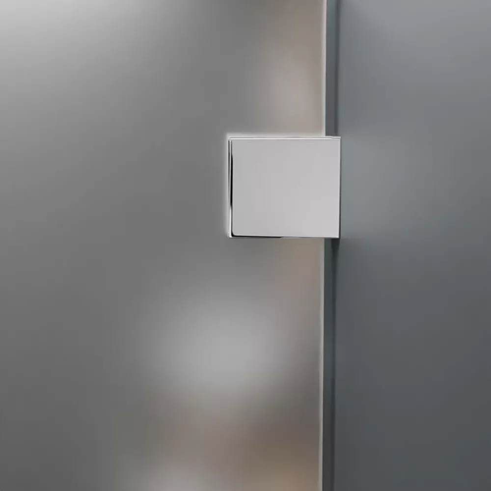 Square chrome glass clamp on frosted shower glass panel showing hardware detail